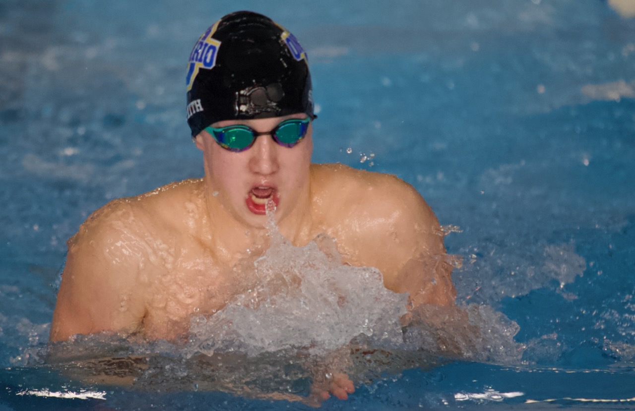a swimmer takes a breath during the breaststroke
