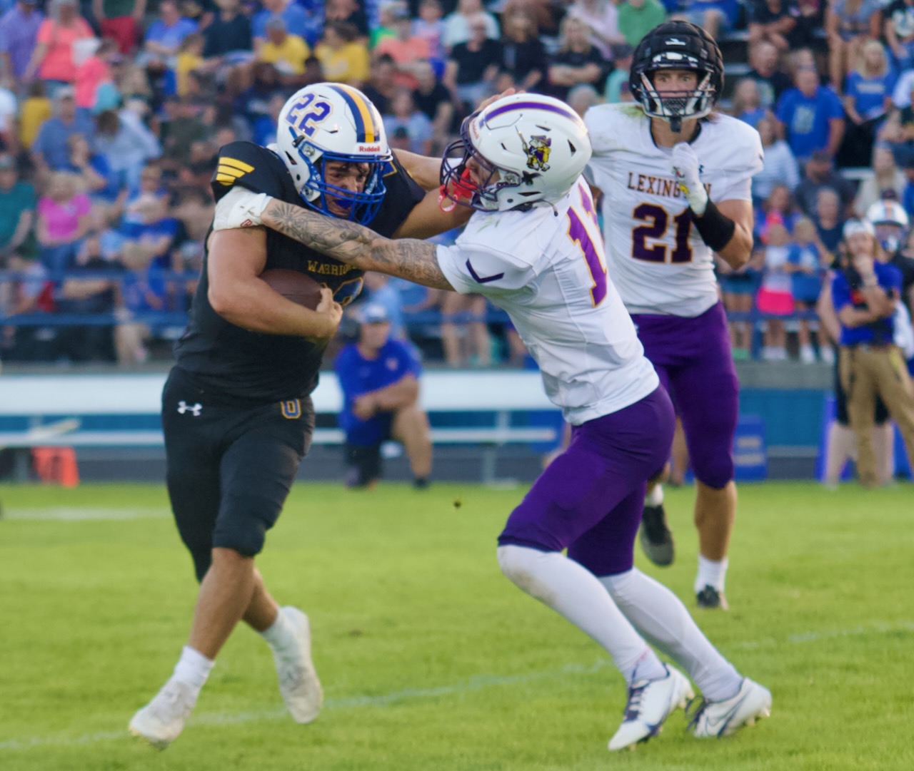 a running back breaks a tackle