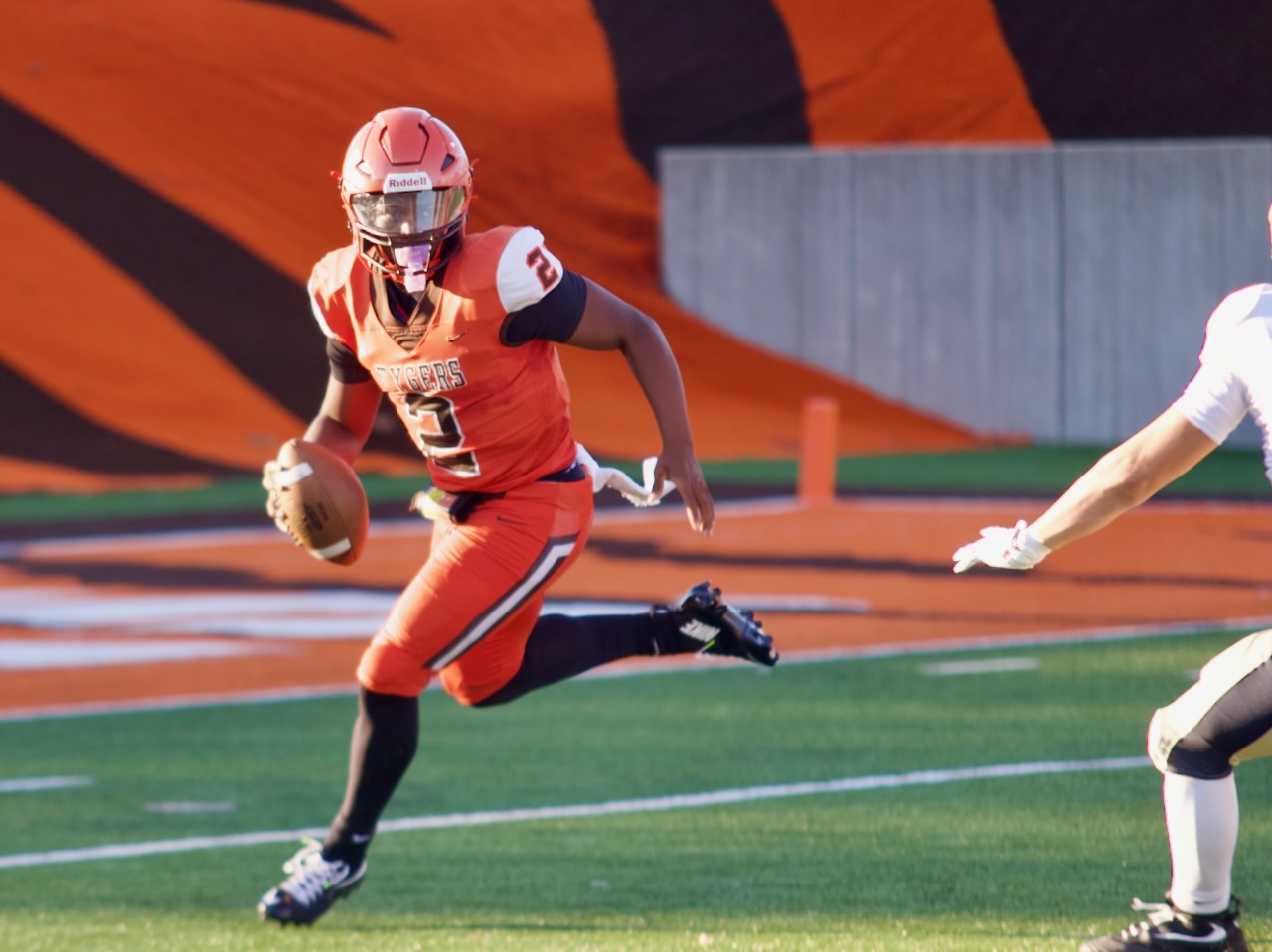 A quarterback scrambles out of trouble