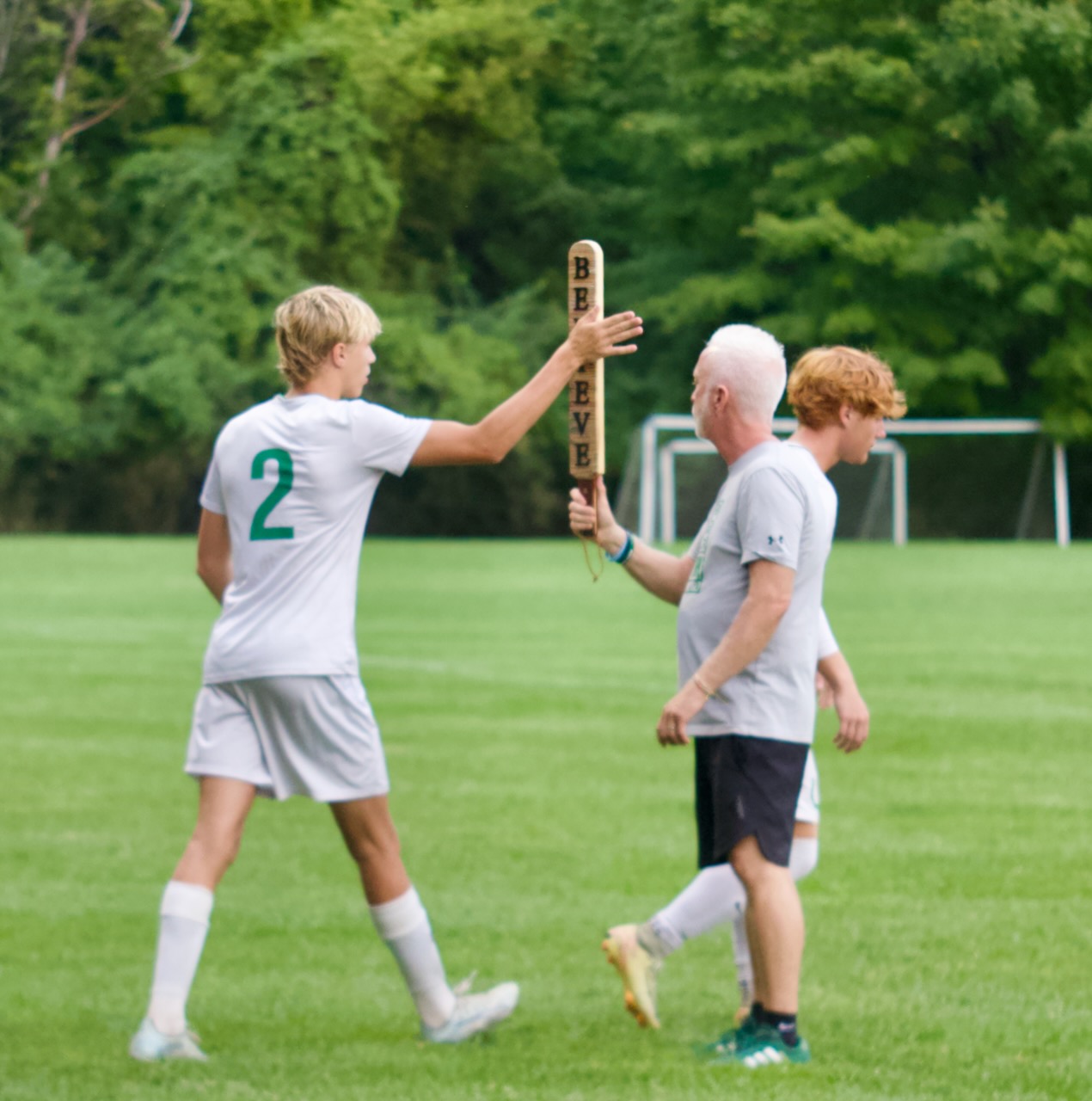 a player touches a sign held by an assistant coach