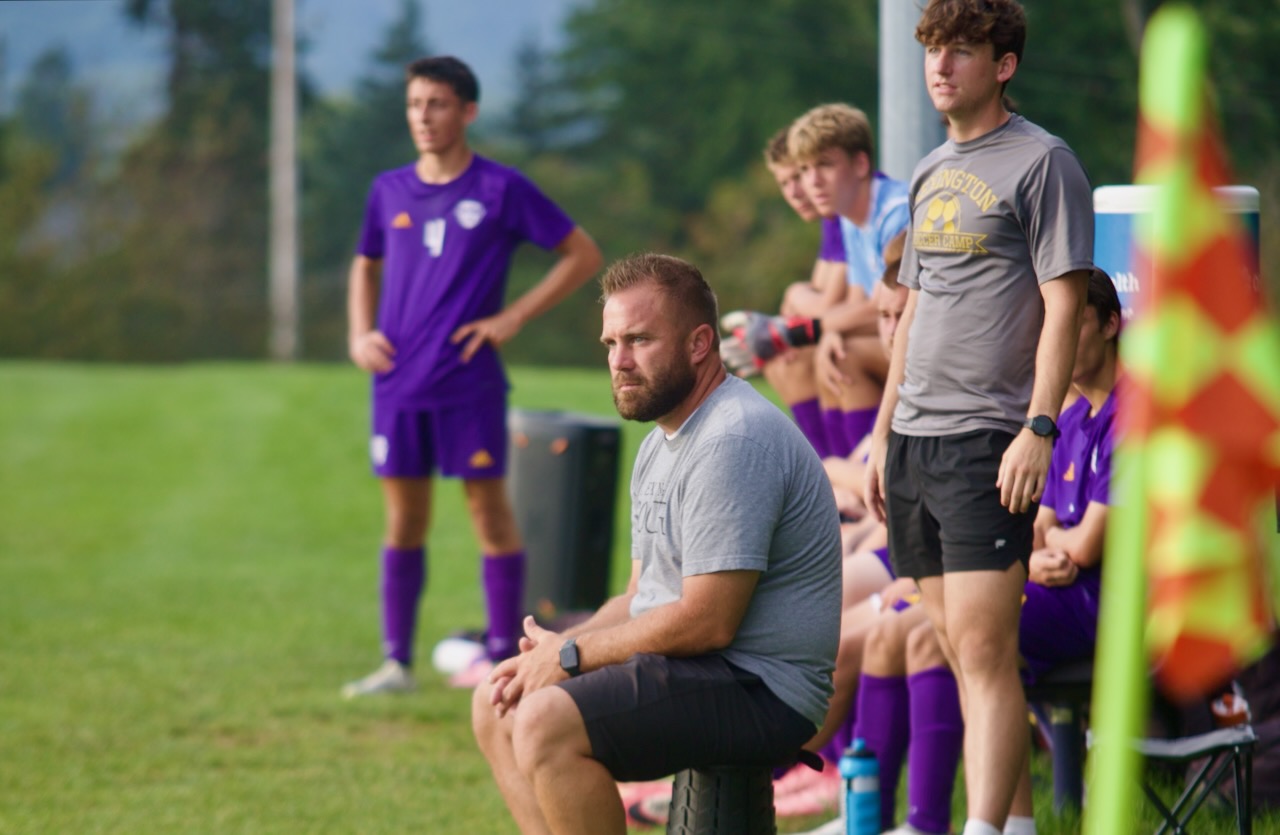 a coach follows the action on the field