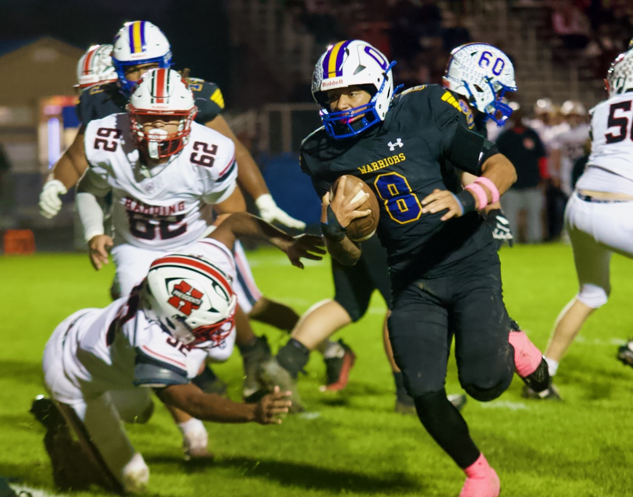 a running back looks for an opening in the defense