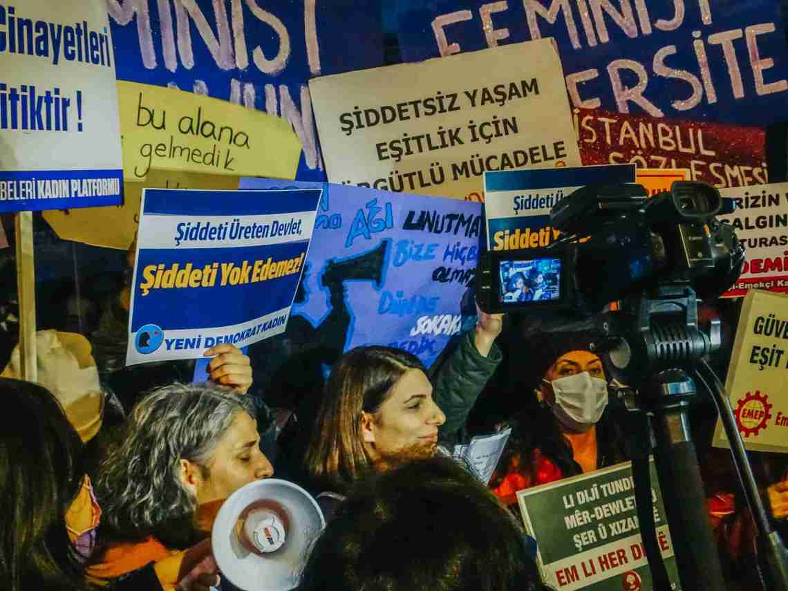 Surrounded by placards and feminist activists, a woman delivers a speech during the International Day Against Violence Against Women on 25 November in Kizilay