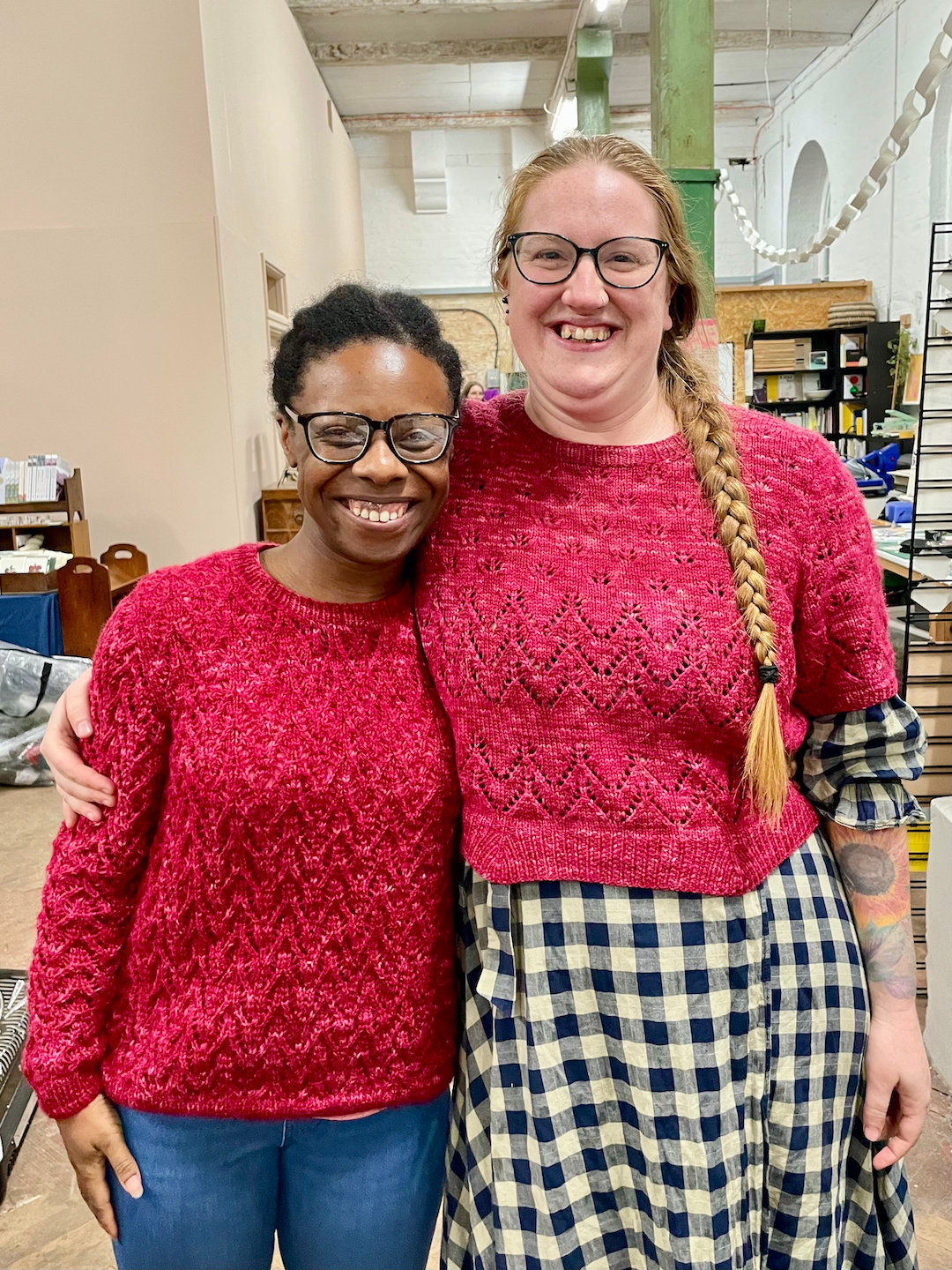 Becci and Natalie Warner hug in matching jumpers and smile at the camera