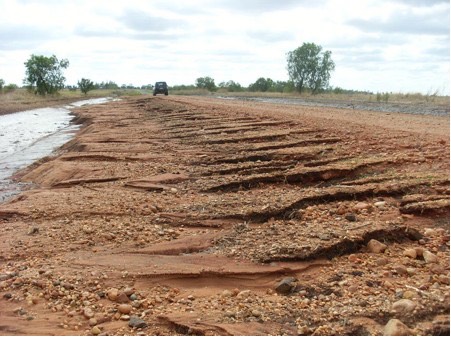 Polycom treated road survived flooding but untreated shoulders scoured