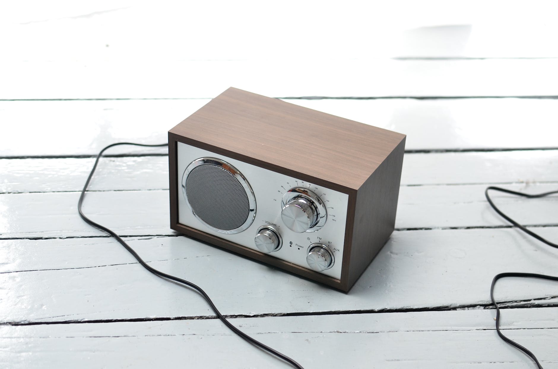 retro radio with metal front placed on wooden table