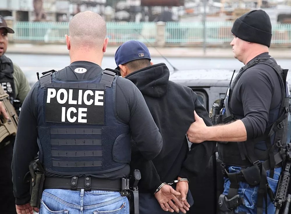 U.S. Immigration and Customs Enforcement officers carry out an arrest as part of a nationwide enforcement sweep.