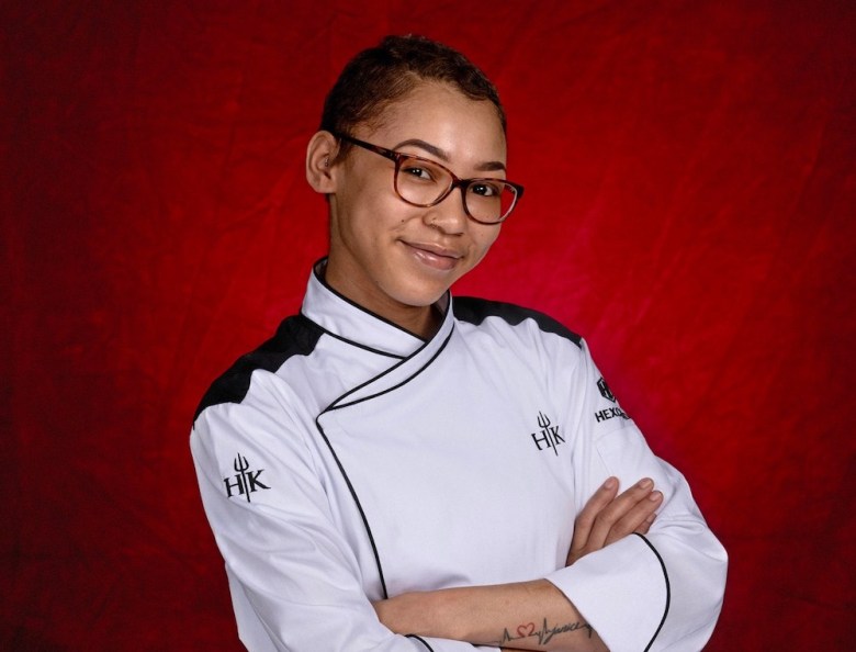 24-year-old Anaiya Marie, sous chef at Chef Bruce Auden's River Walk landmark Biga on the Banks, poses in chef uniform with arms crossed.