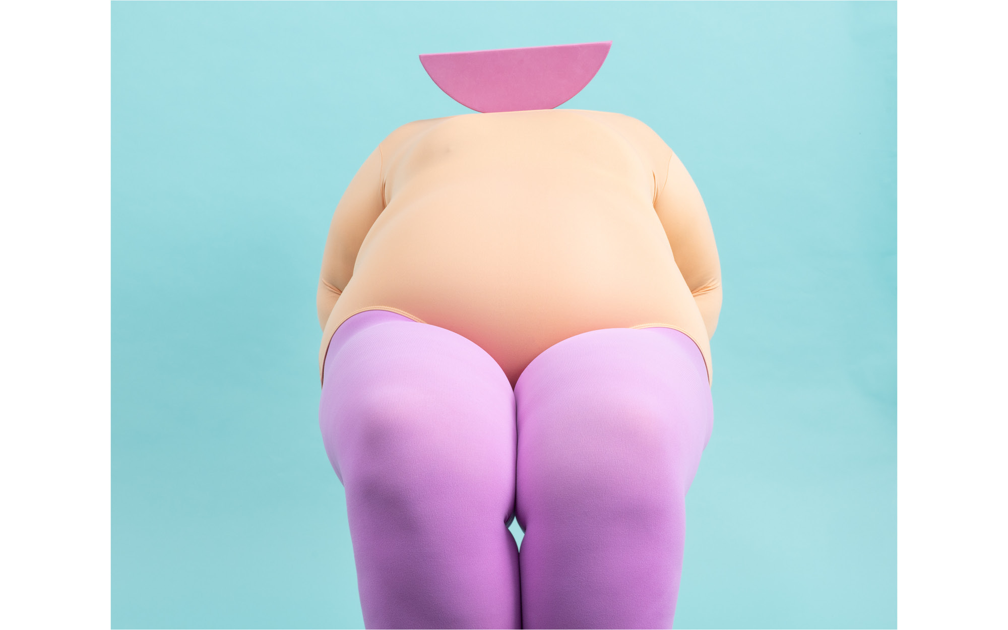 person in a leotard with a semi circle for their head