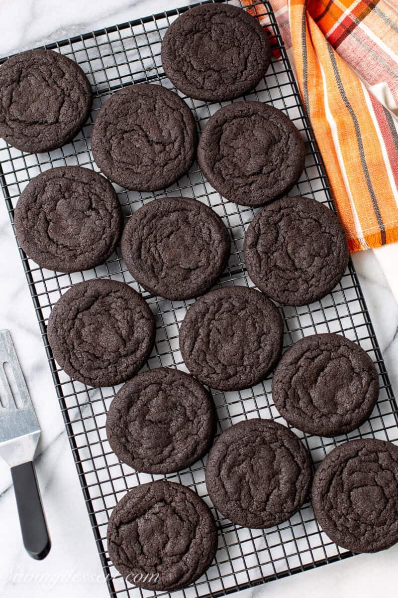 Black cocoa cookies on a cooking rack.