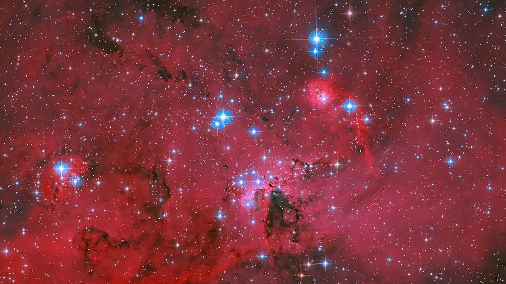 Stellar Nursery LH 95: Hubble Captures Crimson Fireworks (2026)