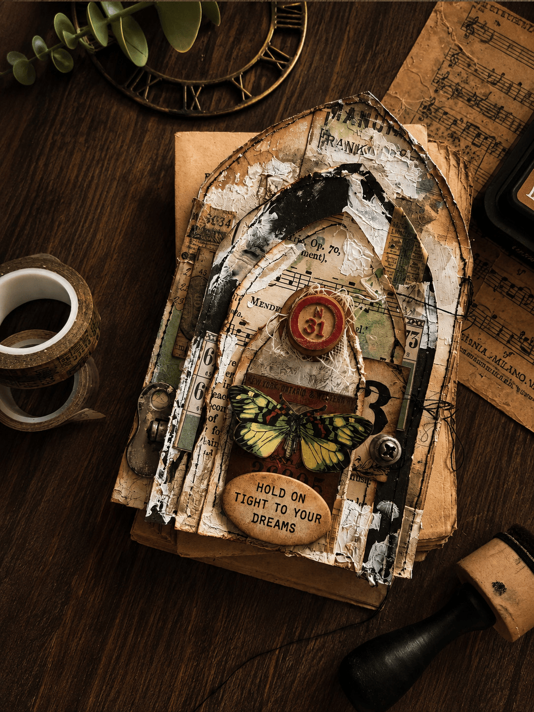 mixed media arch project with layered Tim Holtz papers, stitching, crackle texture and butterfly
