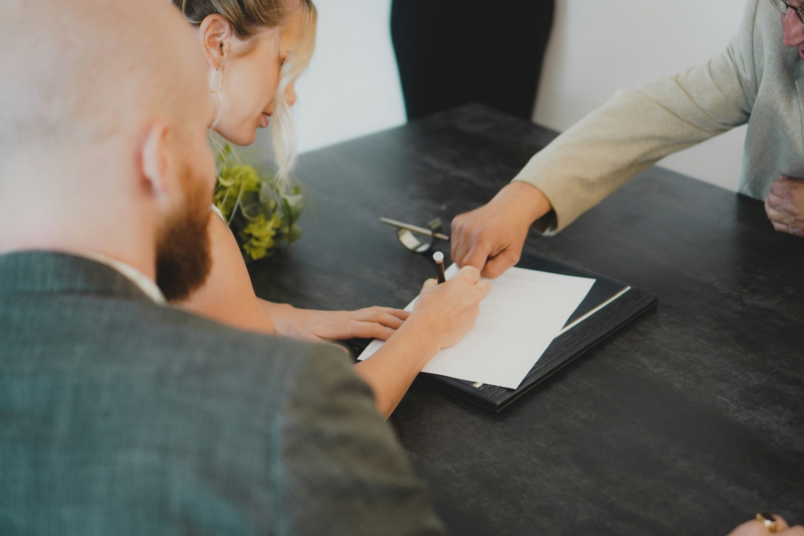 People reviewing and signing paperwork