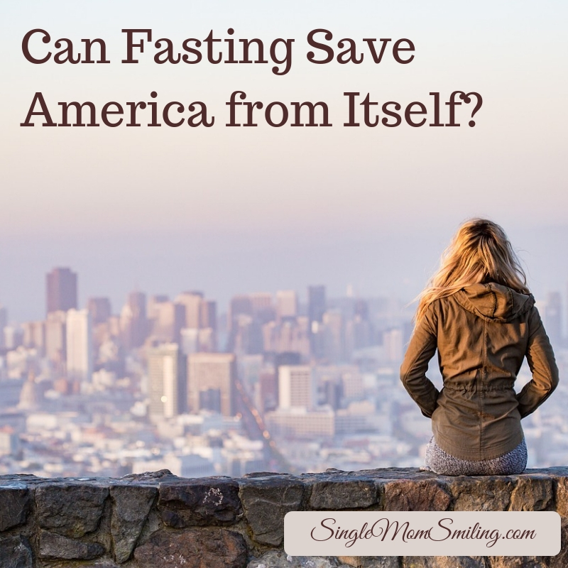 Can Fasting Save America from Itself? Woman on wall overlooking city