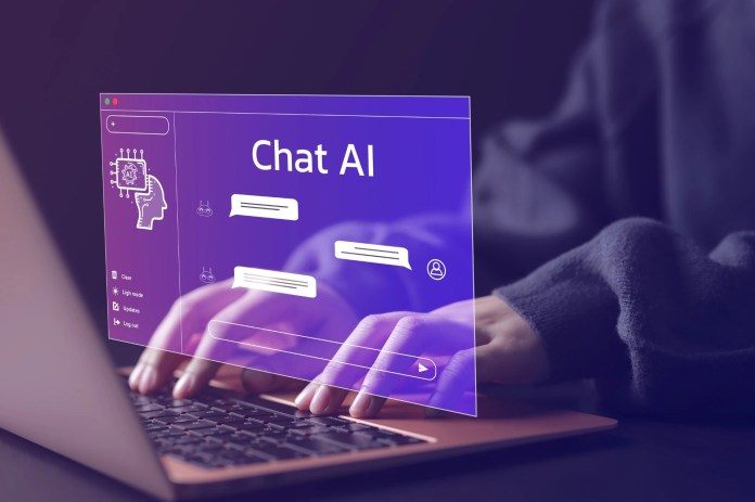 AI Chat Interfaces Are Changing How We Discover Information Online Person typing on a laptop with a glowing virtual interface labeled