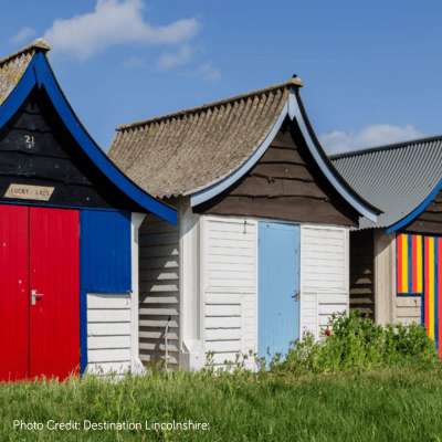 Two colourful beach huts