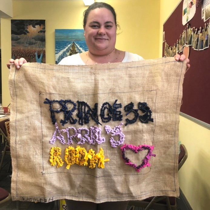 A person holding a piece of cloth with embroidery