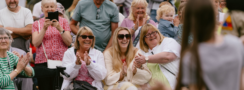 A group of people laughing and clapping