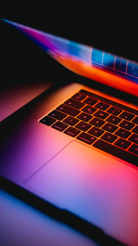 Semi opened laptop with colorful light.
