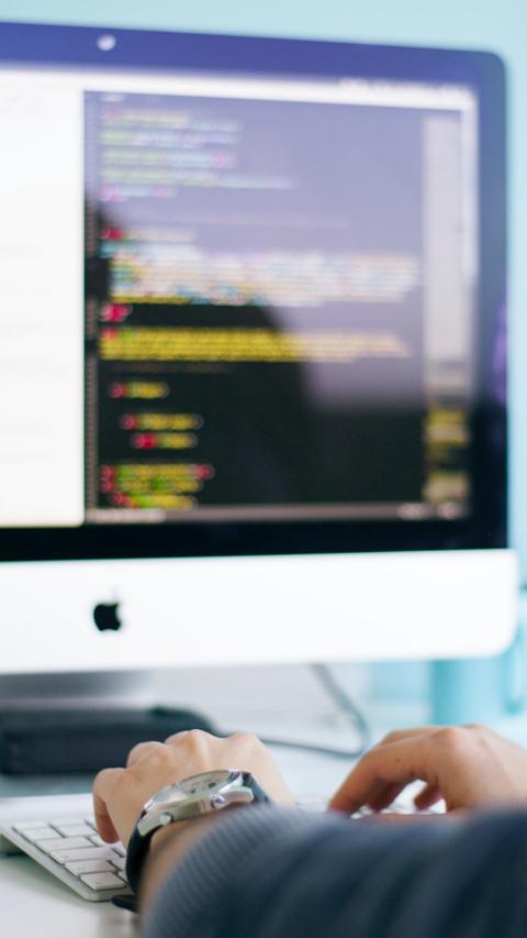 Person typing on a computer.