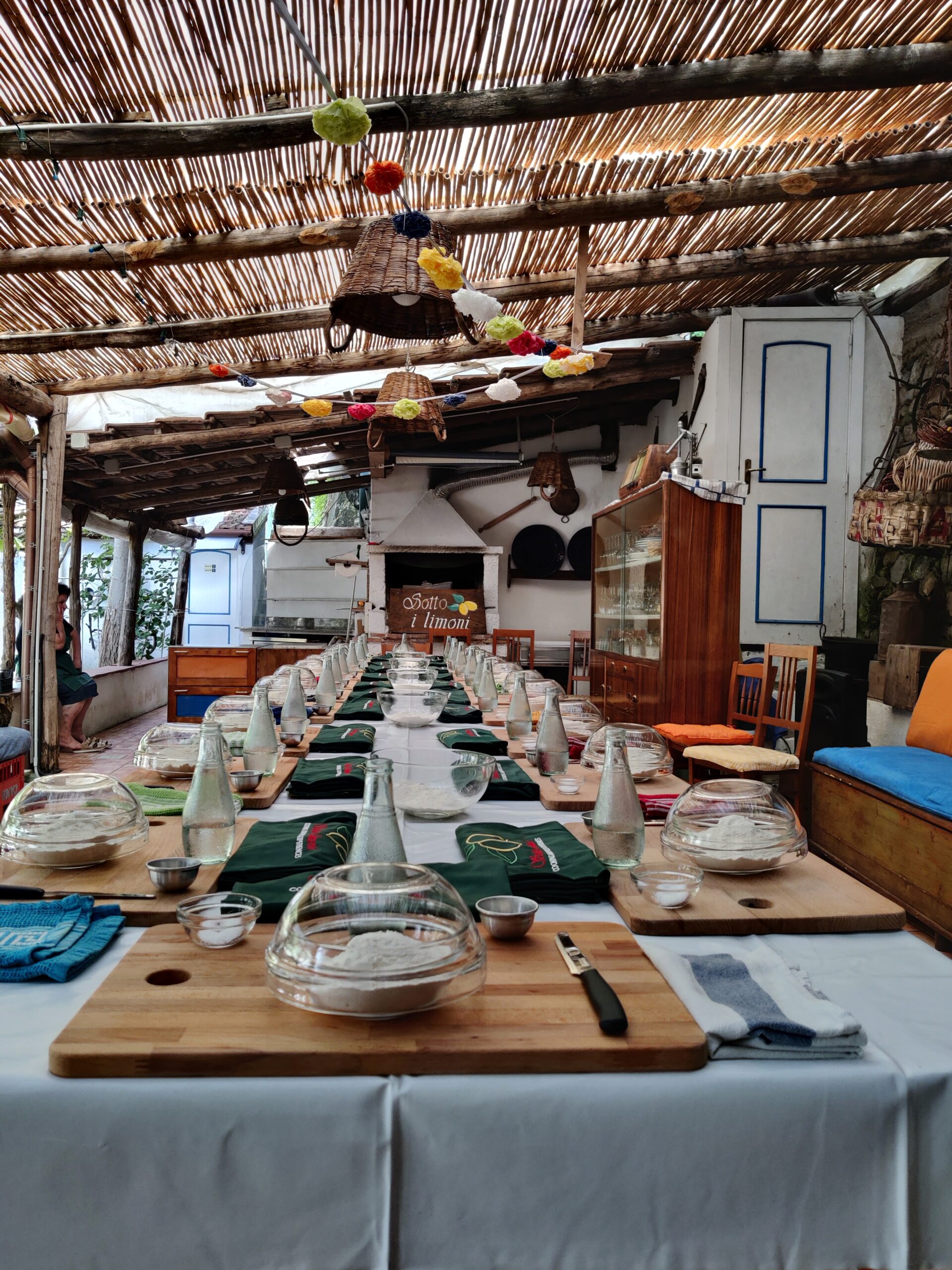 Our covered terrace, set with long tables under a solid bamboo roof