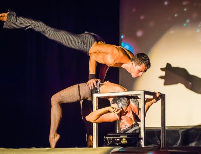 Cube Contortion Show by Soulfire Productions, Kauai, Hawaii Two fit dancers perform a cube contortion routine on stage in Hawaii