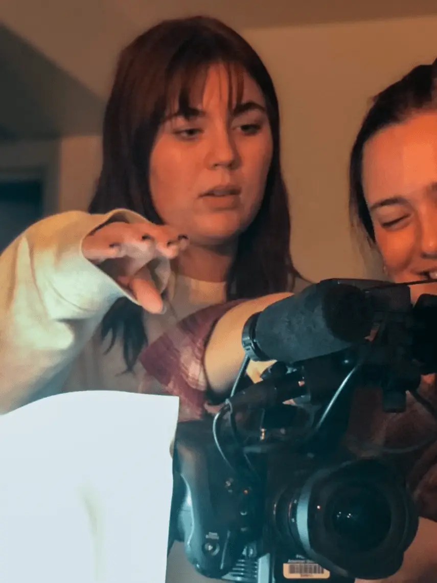 A woman directing with a camera