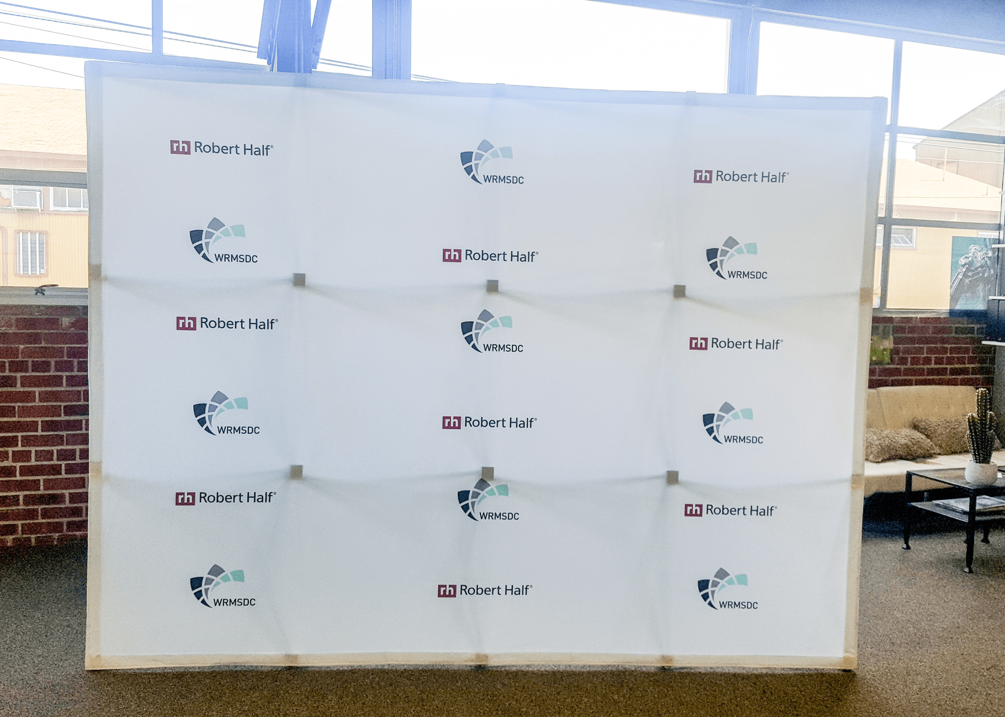 Large step and repeat banner displaying Robert Half and WRMSDC logos.