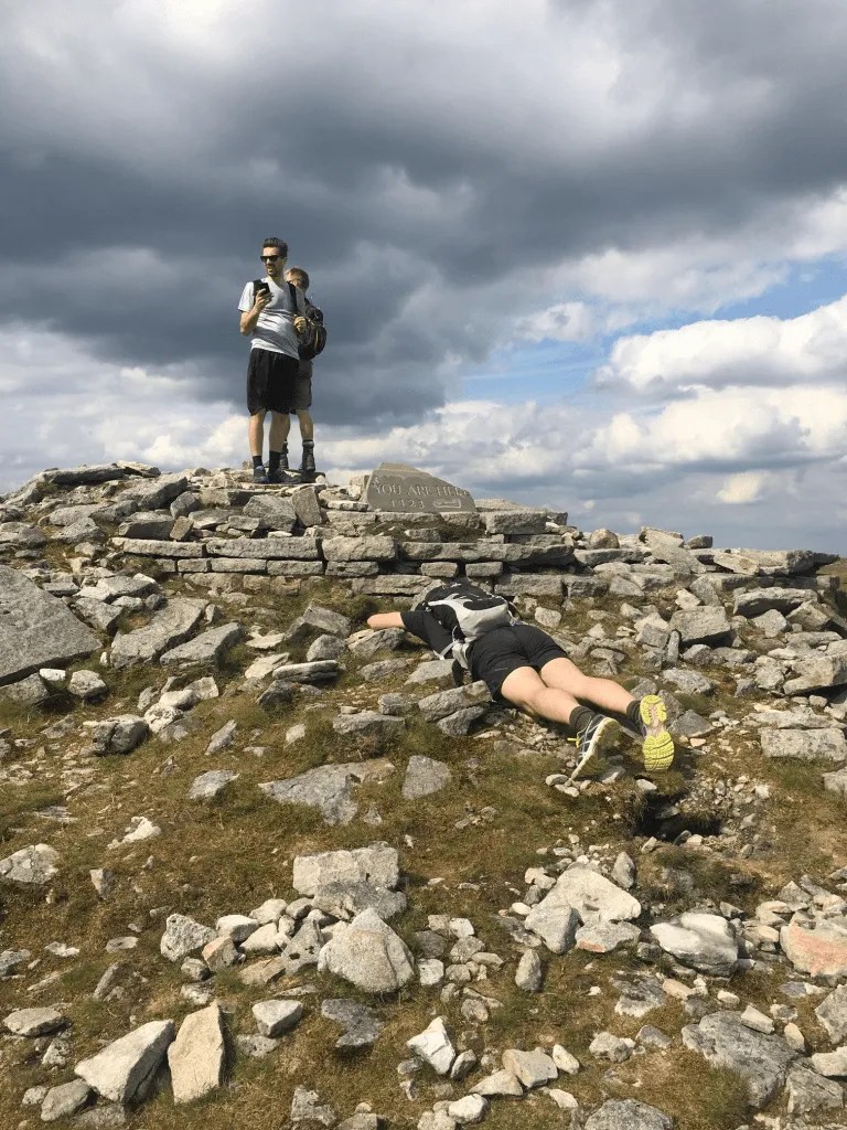 Two members of the Mac Recycle team at the summit cairn during the Yorkshire Three Peaks challenge