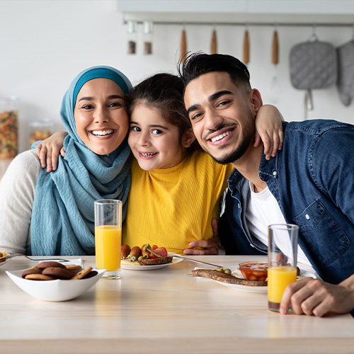 Smiling family having a breakfast