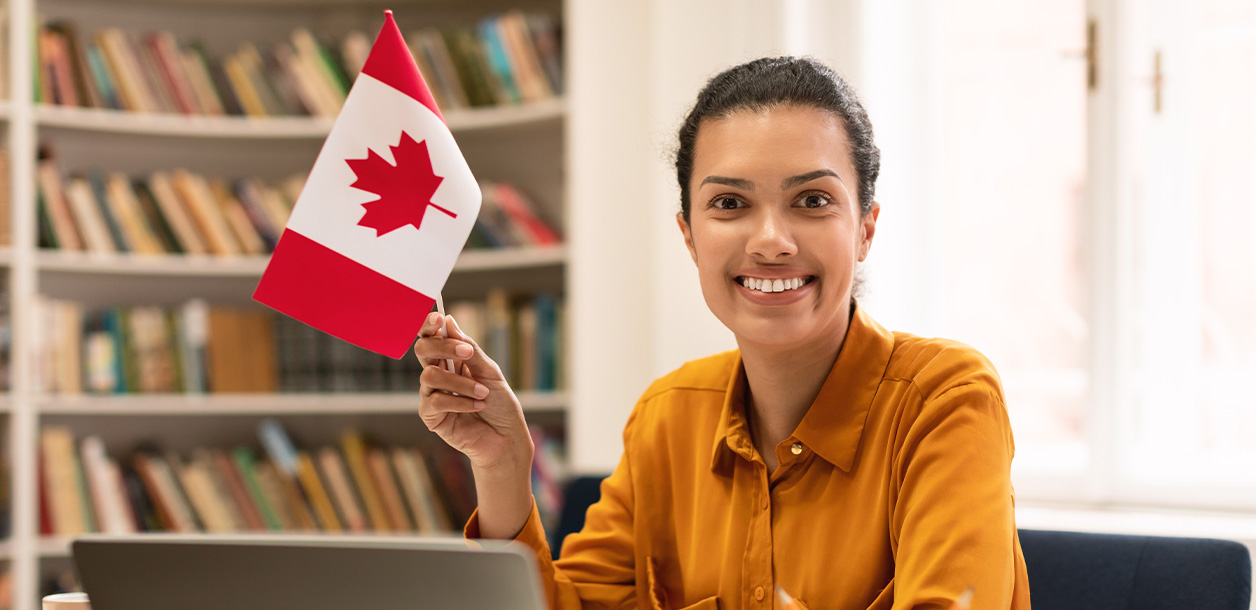 Smiling girl holding Canadian flag