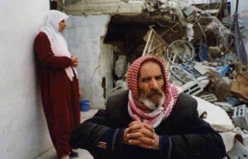 copyright Joel Carillet Abu Rajah and his wife, one week after the Israeli army demolished all but one room of their house to make way for tanks in their crowded refugee camp. When I visited Jenin Refugee Camp in 2002 and had no place to stay, Abu Rajah invited me, a complete stranger, to stay with his family in the one room still standing. Two of his sons had already been killed by the Israeli Defense Force (one died of an asthma attack brought on by tear gas, forbidden by the soldiers to leave their house to go to a nearby hospital for treatment). During my stay, Abu Rajah and his wife asked that I make time to talk with their third son, a 17-year old who hoped to be a suicide bomber. Their hope: that an outsider would have more influence than parents in discouraging a child from committing such a terrible act.