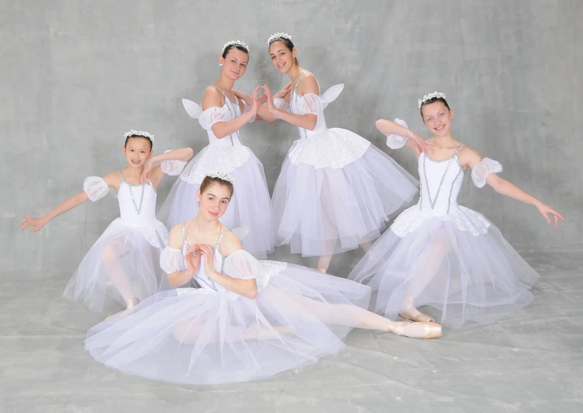 a group of ballet dancers in white tutu dresses