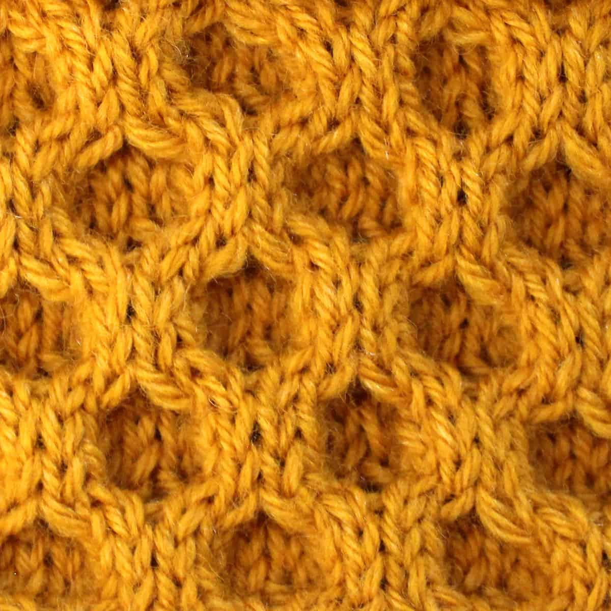 A moderate level pattern that includes using a cable needle. Honeycomb Cable Stitch Knitting Pattern Studio Knit