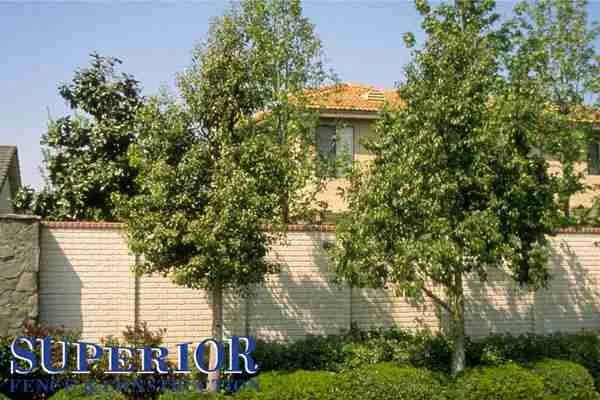 Buff brick with red cap pre-cast concrete fence - Superior Fence