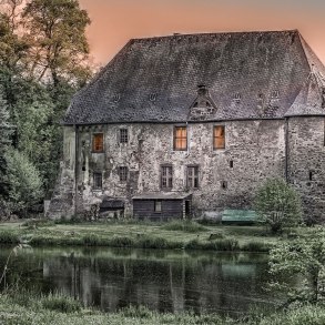 Old cottage among trees