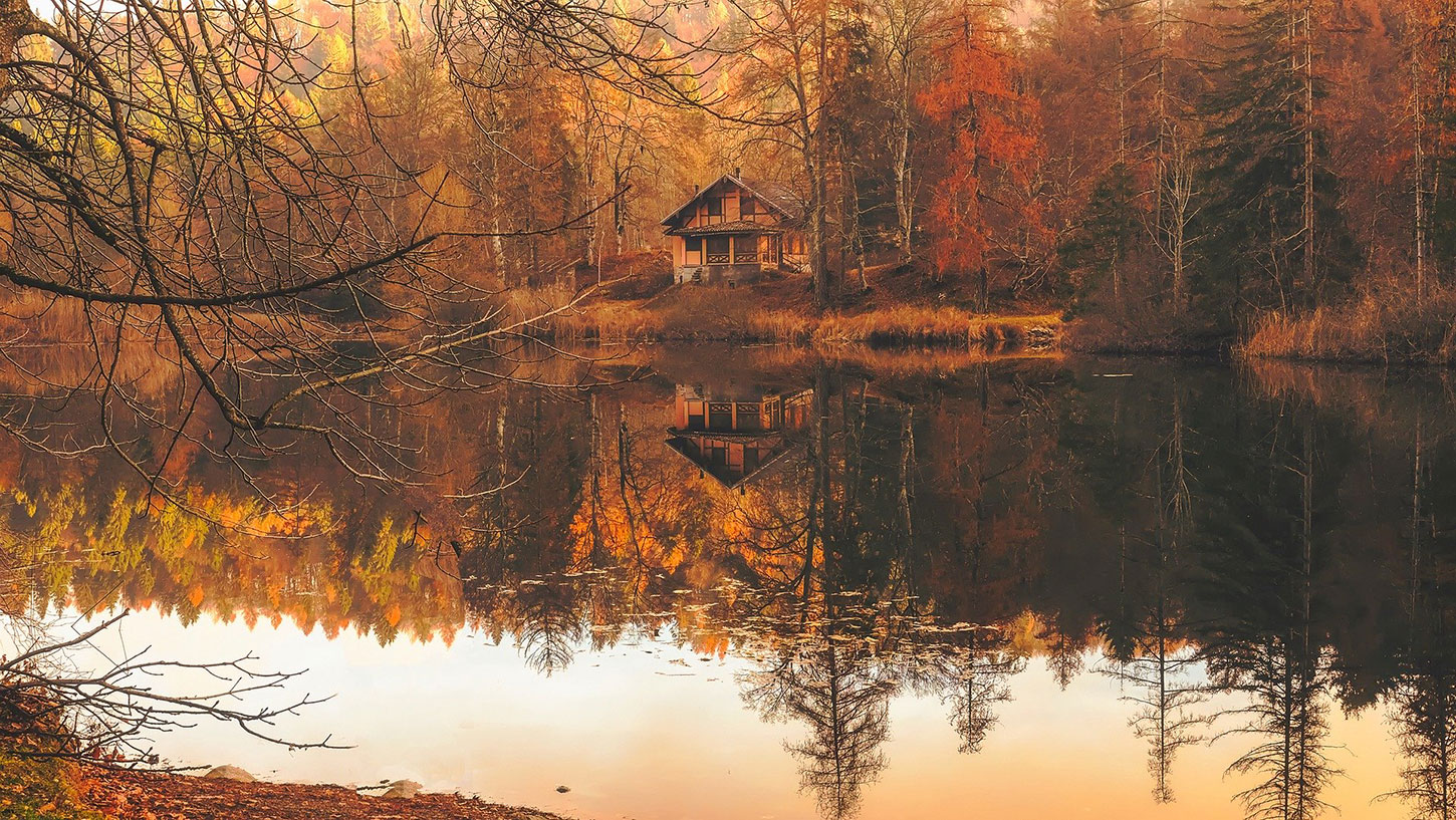 A cabin on a lake during Autumn