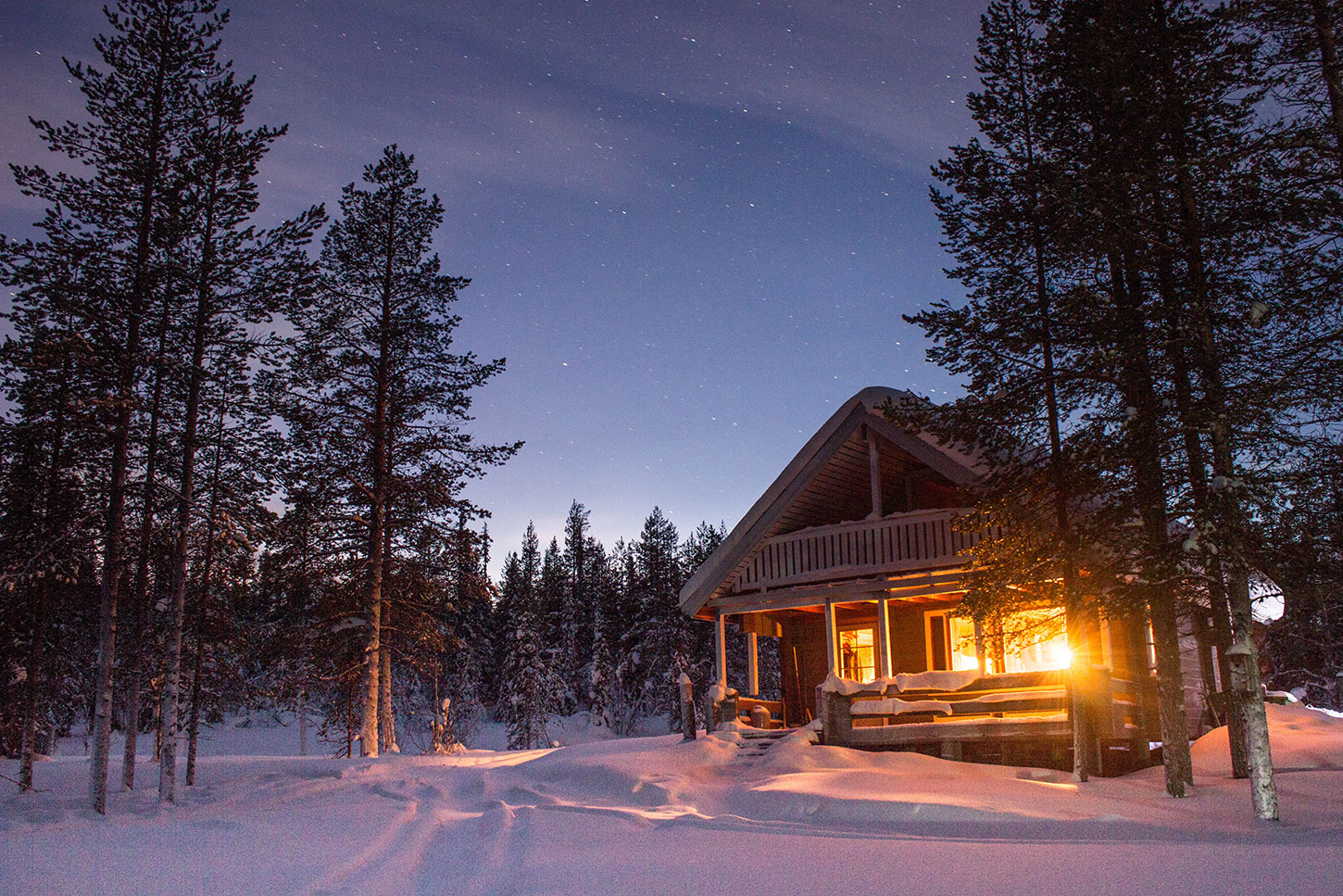 Lit cabin in snow