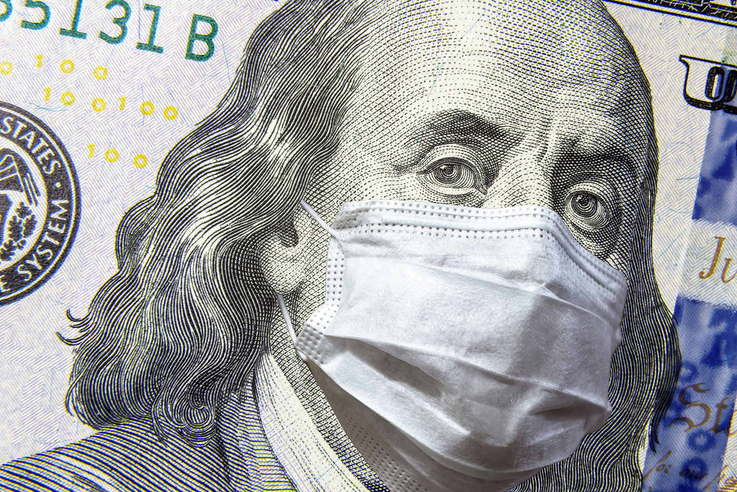 $100 bill with facemask on Ben Franklin