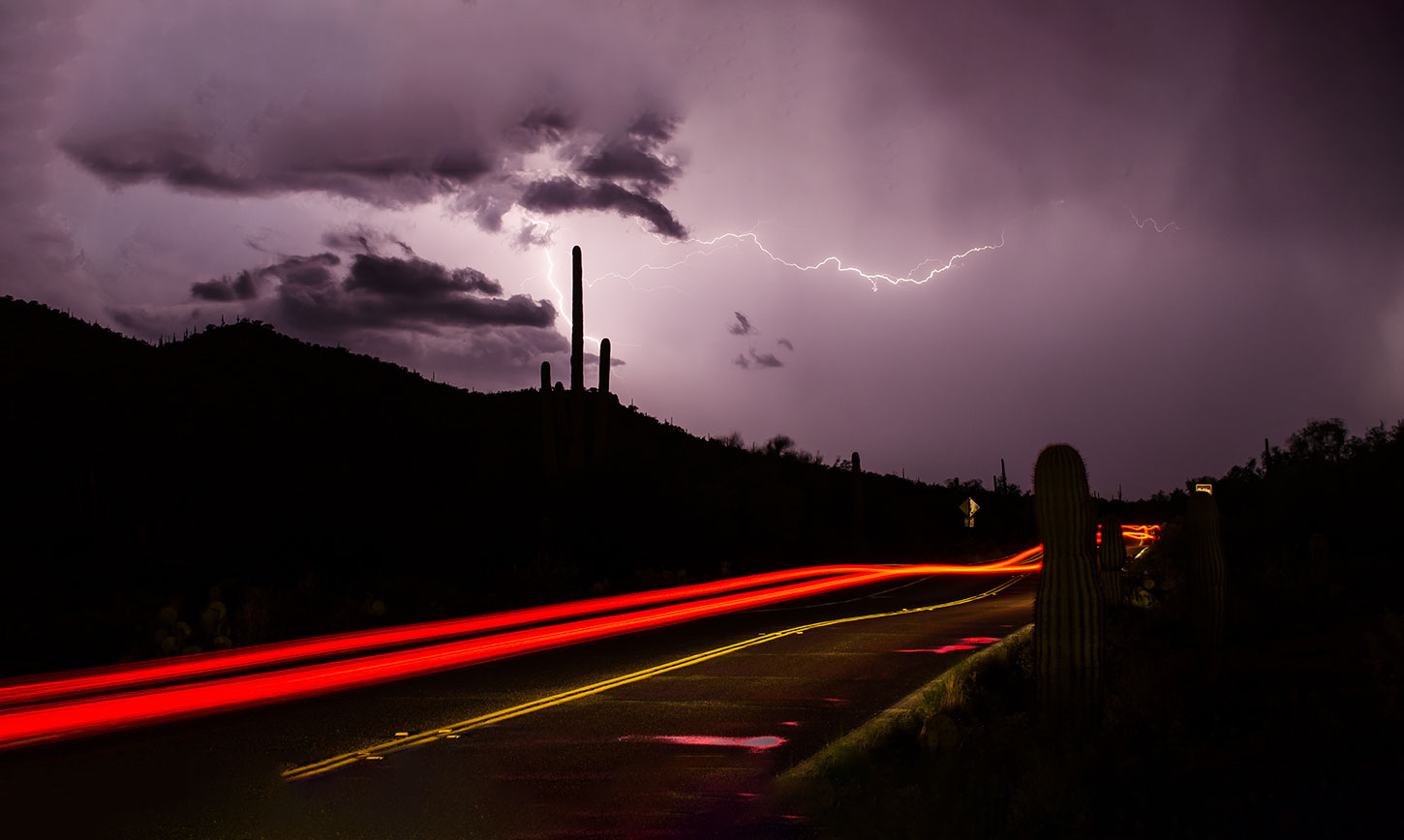 Desert at night, lightning, car taillights