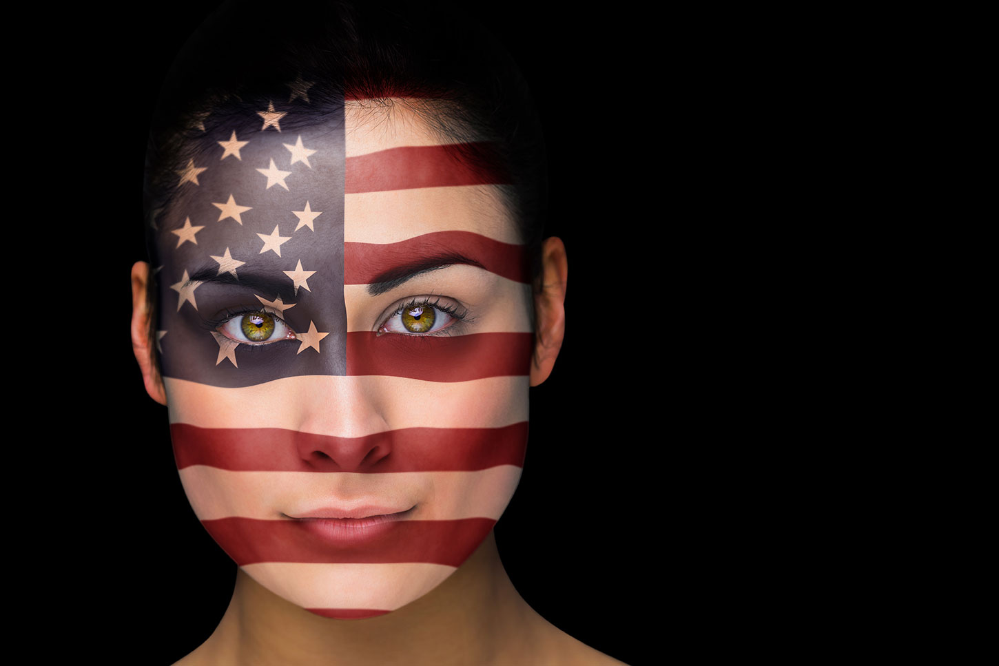 Female face painted with U.S. flag on black background