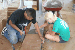 Alex and Eva lay the first earthen blocks on our house