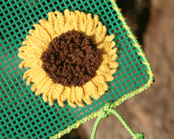 crocheted sunflower appliqued to plastic canvas