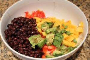 adding beans, mango, avocado