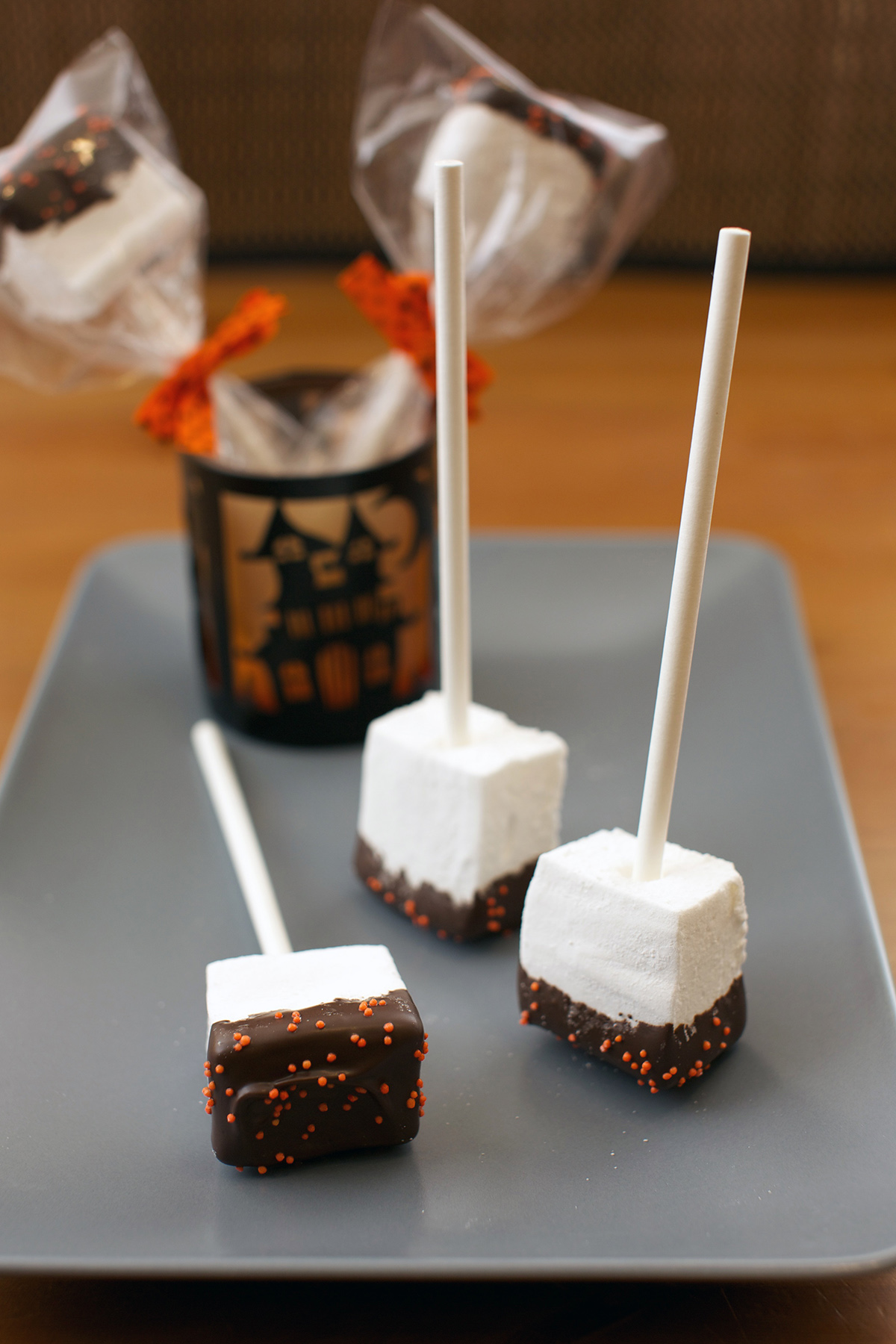 Marshmallow Squares | These cute squares are perfect for halloween! They're half dipped in chocolate and topped with sprinkles. #marshmallow #chocolate #sprinkle #cornsyrup #gelatin #candycoating #halloweenrecipe #dessert #dessertrecipe #candy | The Missing Lokness