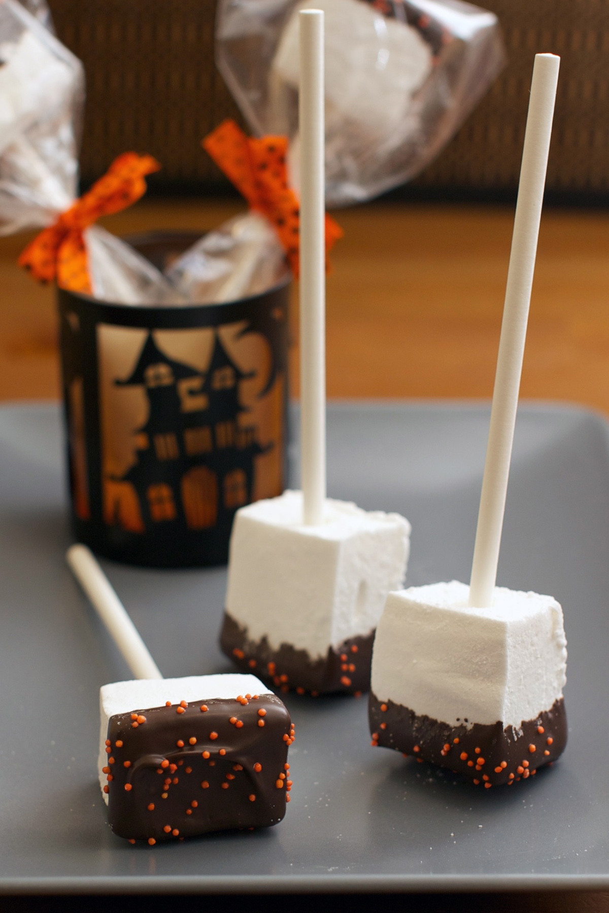 Marshmallow Squares | These cute squares are perfect for halloween! They're half dipped in chocolate and topped with sprinkles. #marshmallow #chocolate #sprinkle #cornsyrup #gelatin #candycoating #halloweenrecipe #dessert #dessertrecipe #candy | The Missing Lokness