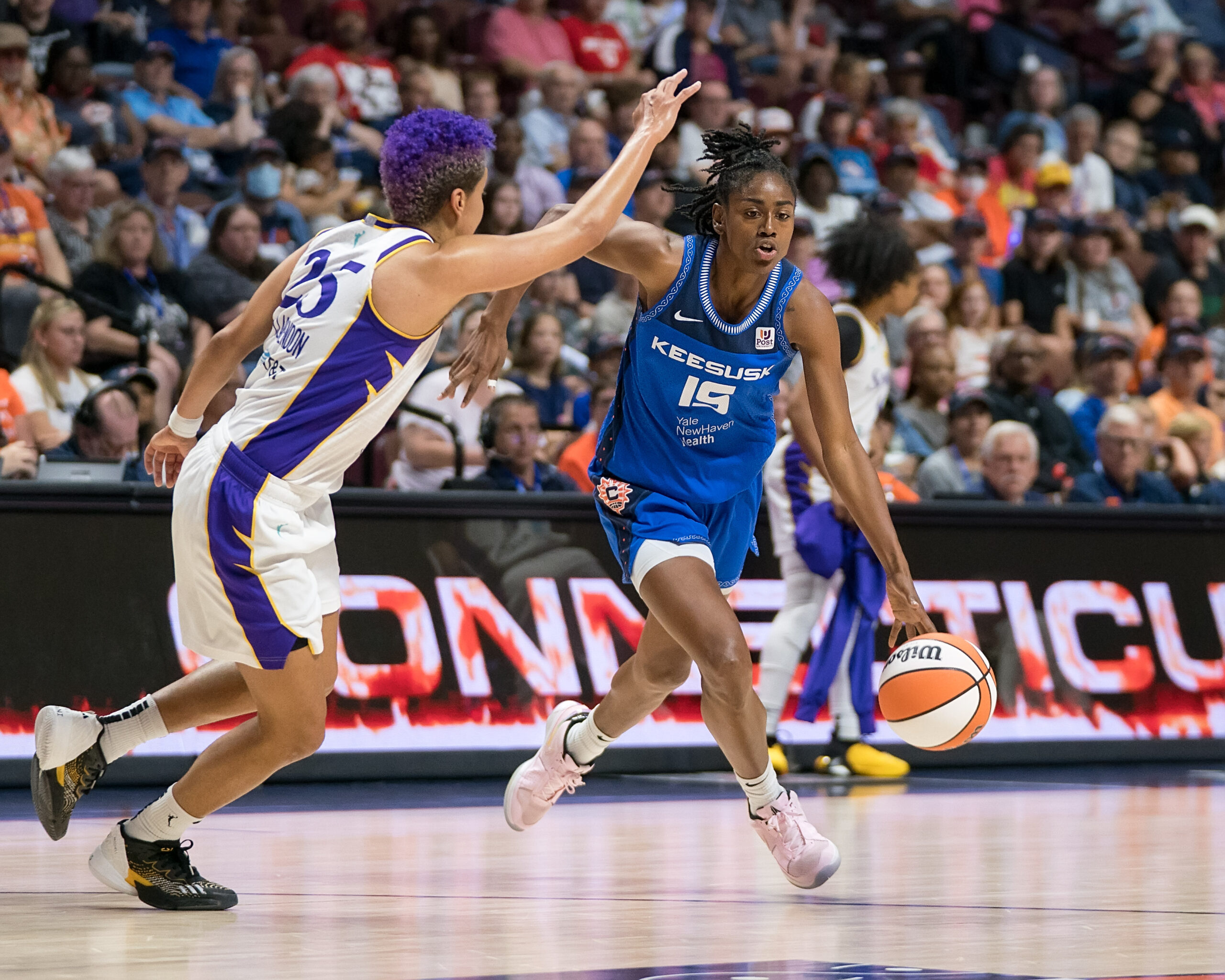 Connecticut Sun guard Tiffany Hayes (15) drives to the basket as Los Angeles Sparks guard Layshia Clarendon (25) defends during the WNBA game between the Los Angeles Sparks and the Connecticut Sun at Mohegan Sun Arena, Uncasville, Connecticut, USA on August 27, 2023. (Photo Credit: Chris Poss)