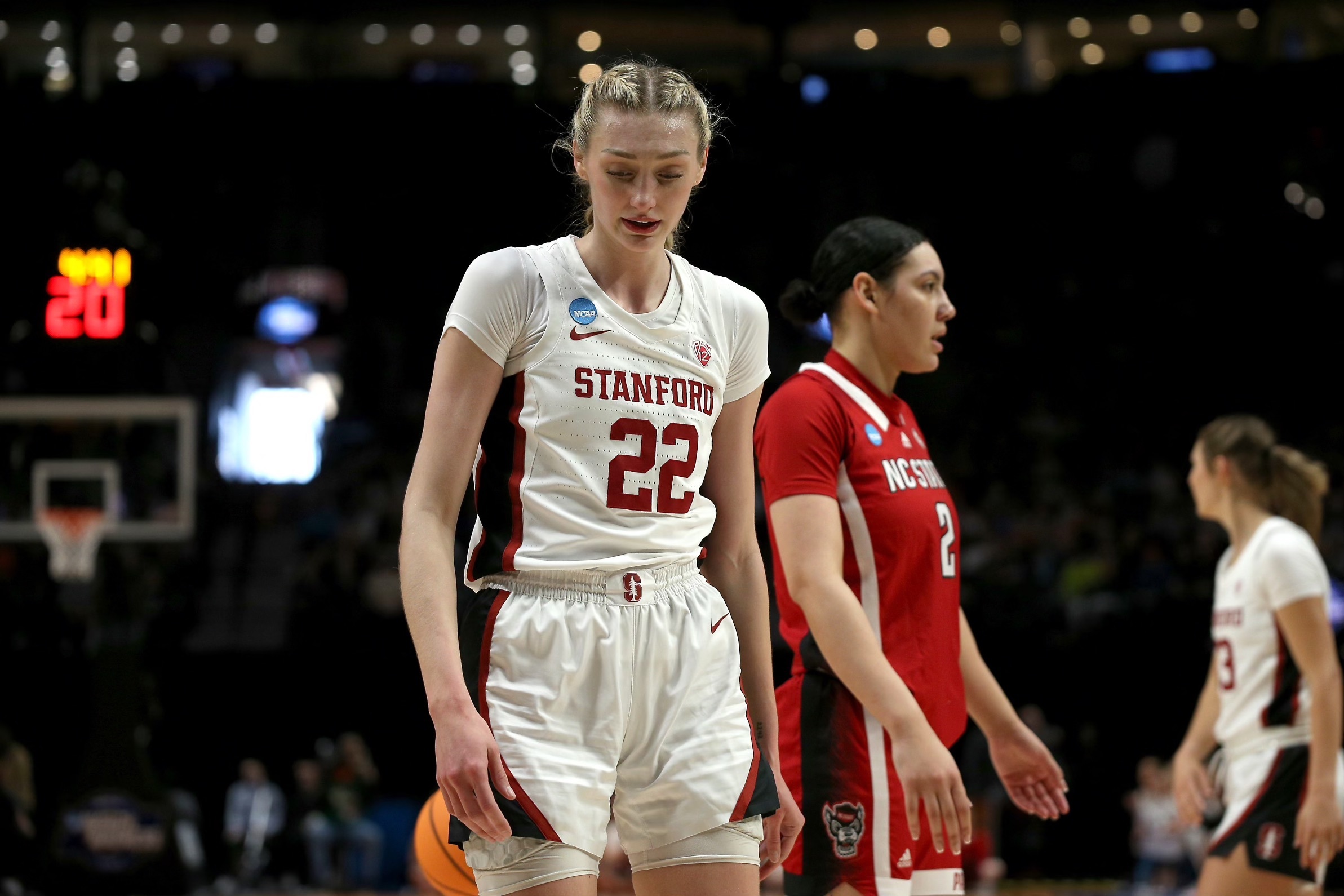 Stanford senior forward Cameron Brink walks on the court with her head down.