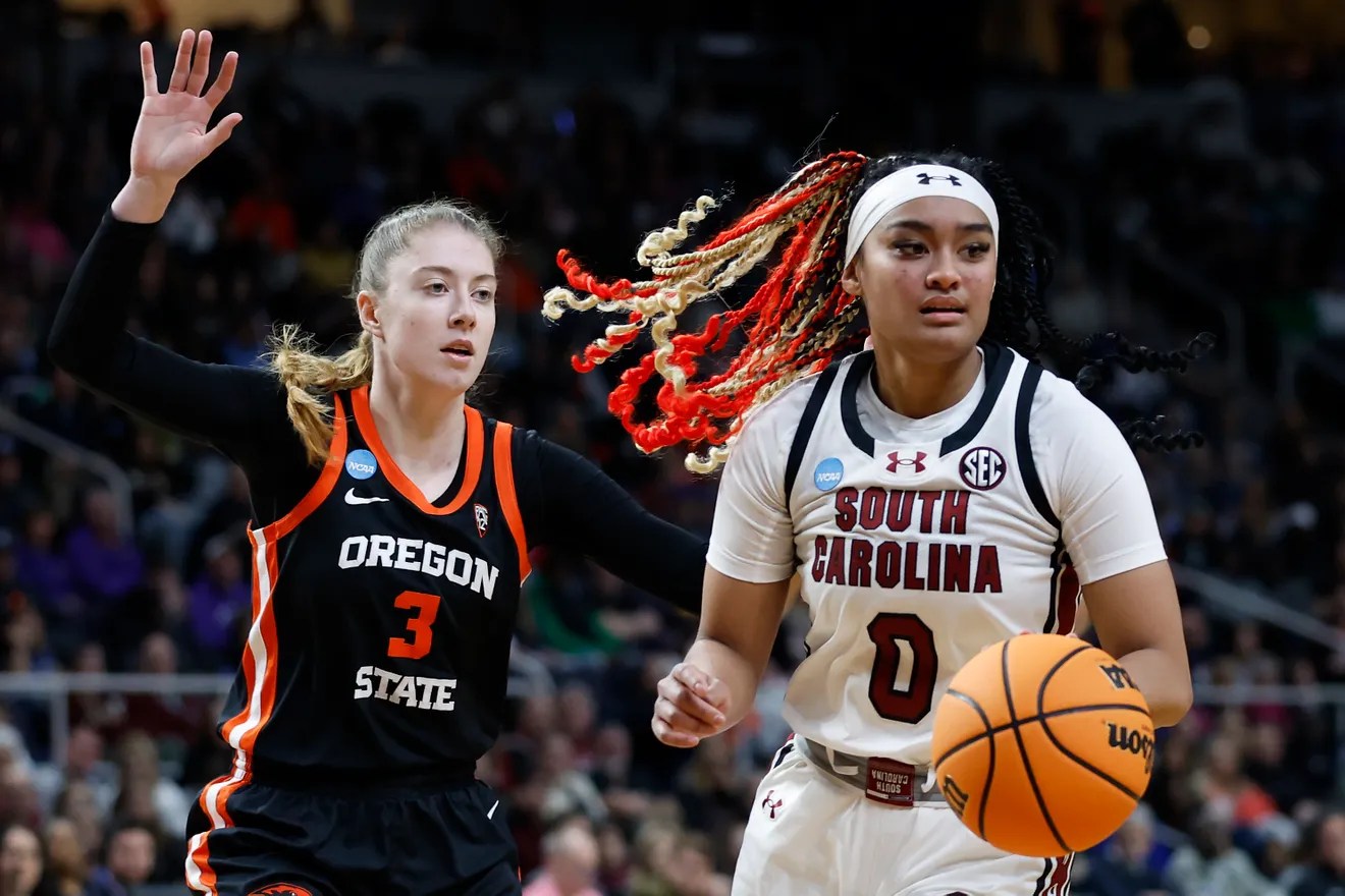 Te-Hina Paopao (No. 0) of the South Carolina Gamecocks stands to the right of the frame in front of Dominika Paurova (No. 3) of the Oregon State Beavers