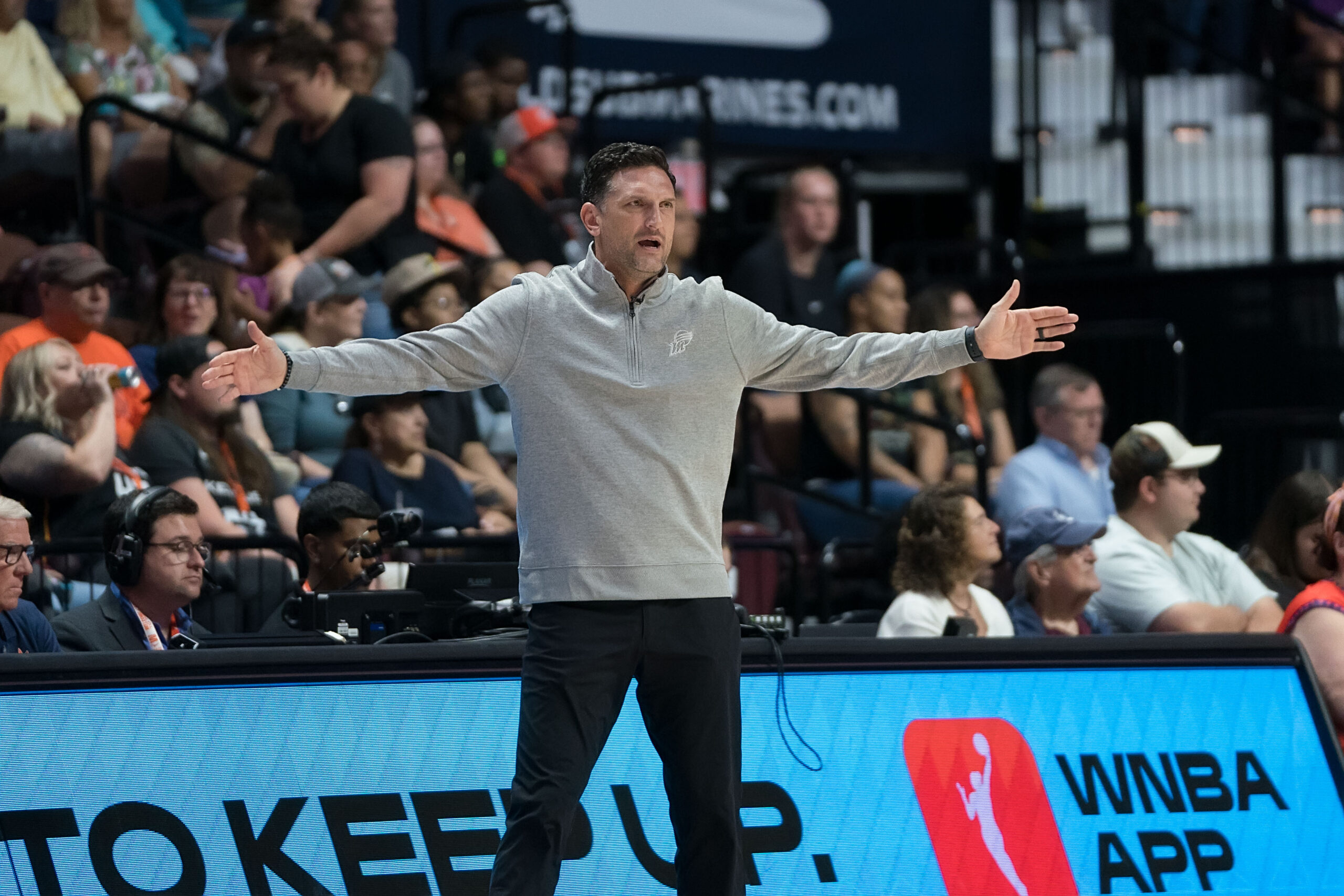 Phoenix Mercury Head Coach Nate Tibbetts stands with his arms outstretched to the sides during a WNBA game between the Phoenix Mercury and the Connecticut Sun